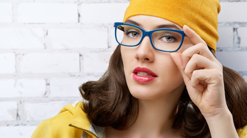 Woman with yellow had and blue glasses